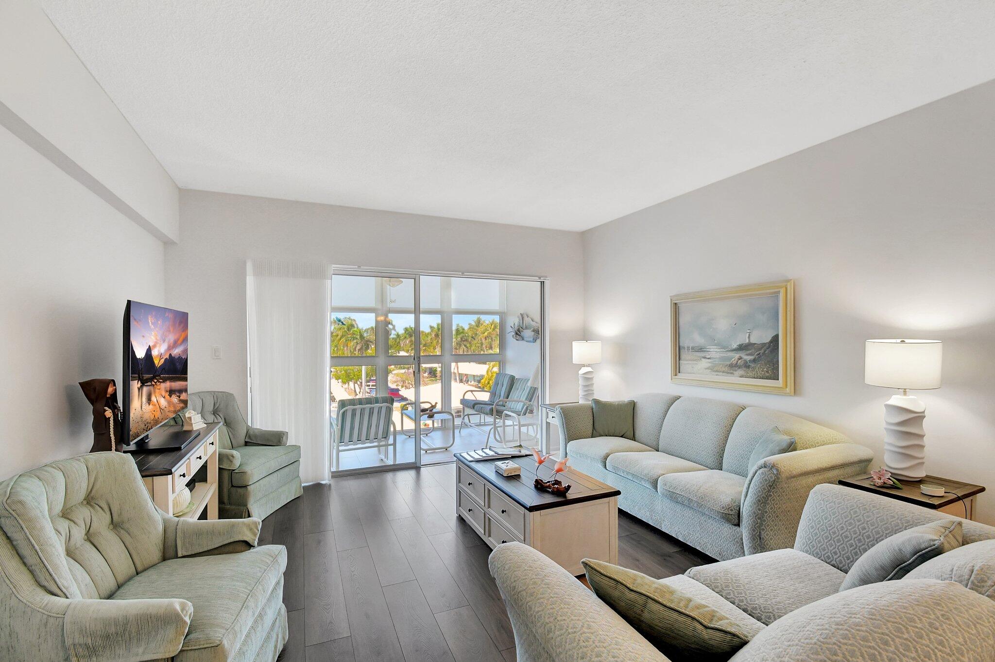 1481 South Ocean Boulevard, Unit 413A Lauderdale-by-the-Sea, FL 33062 - Photo 10 of 48 a living room with furniture and a wooden floor