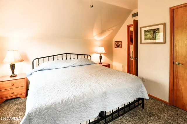 a bedroom with a bed and a night stand