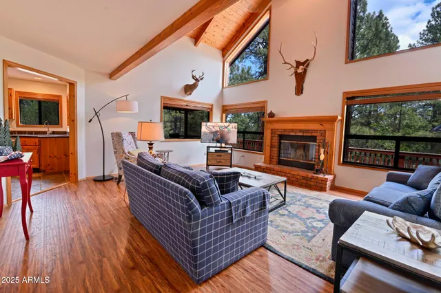 a living room with fireplace furniture and a floor to ceiling window