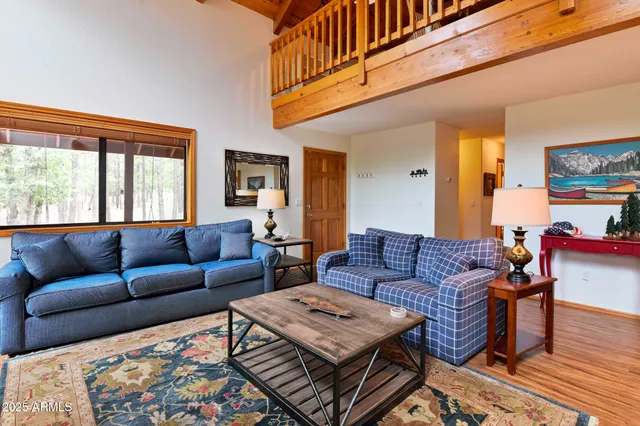 a living room with furniture a couch and a window