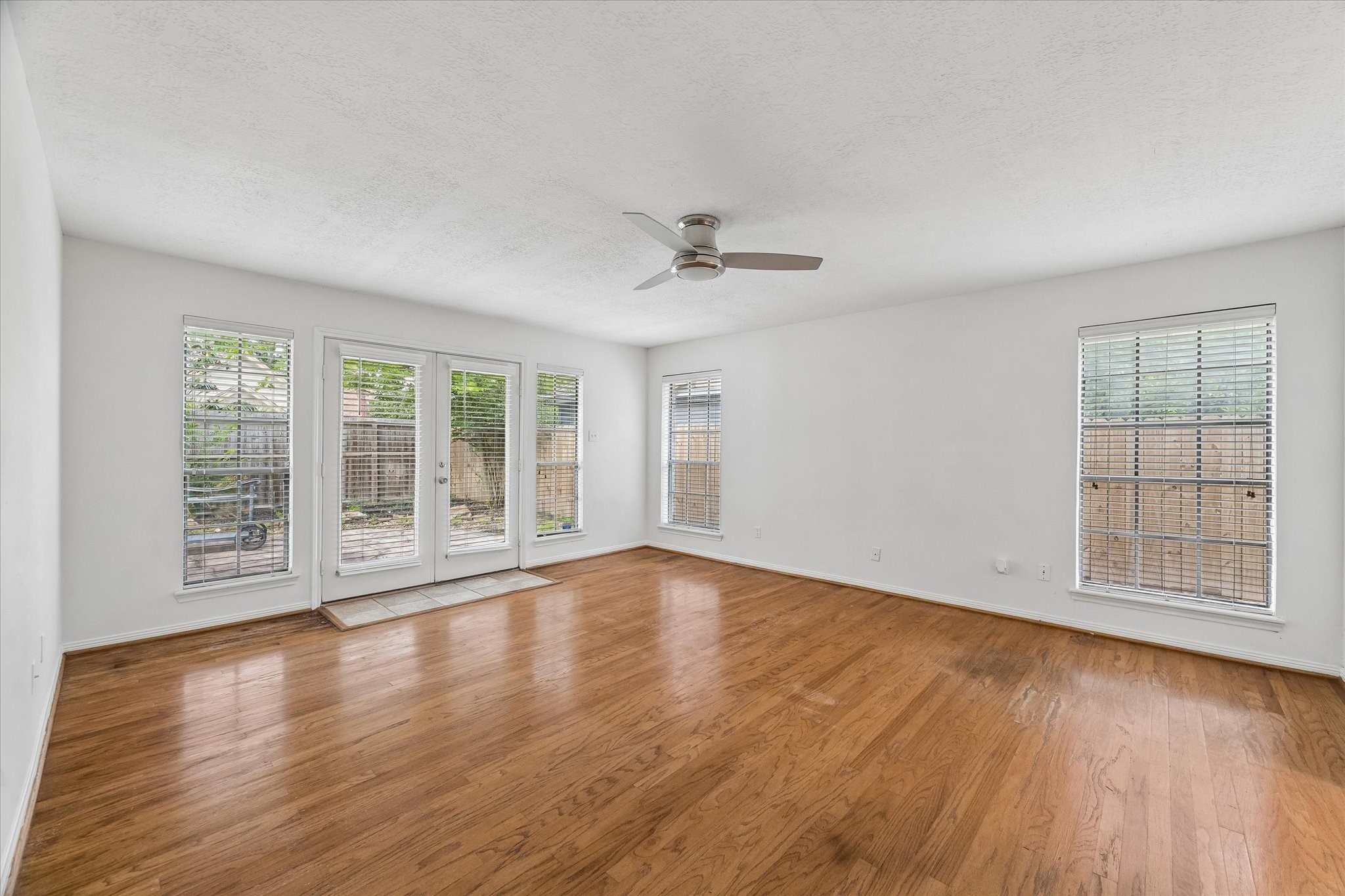 17902 Fernbluff Drive Spring, TX 77379 - Photo 15 of 29 wooden floor in an empty room with a window