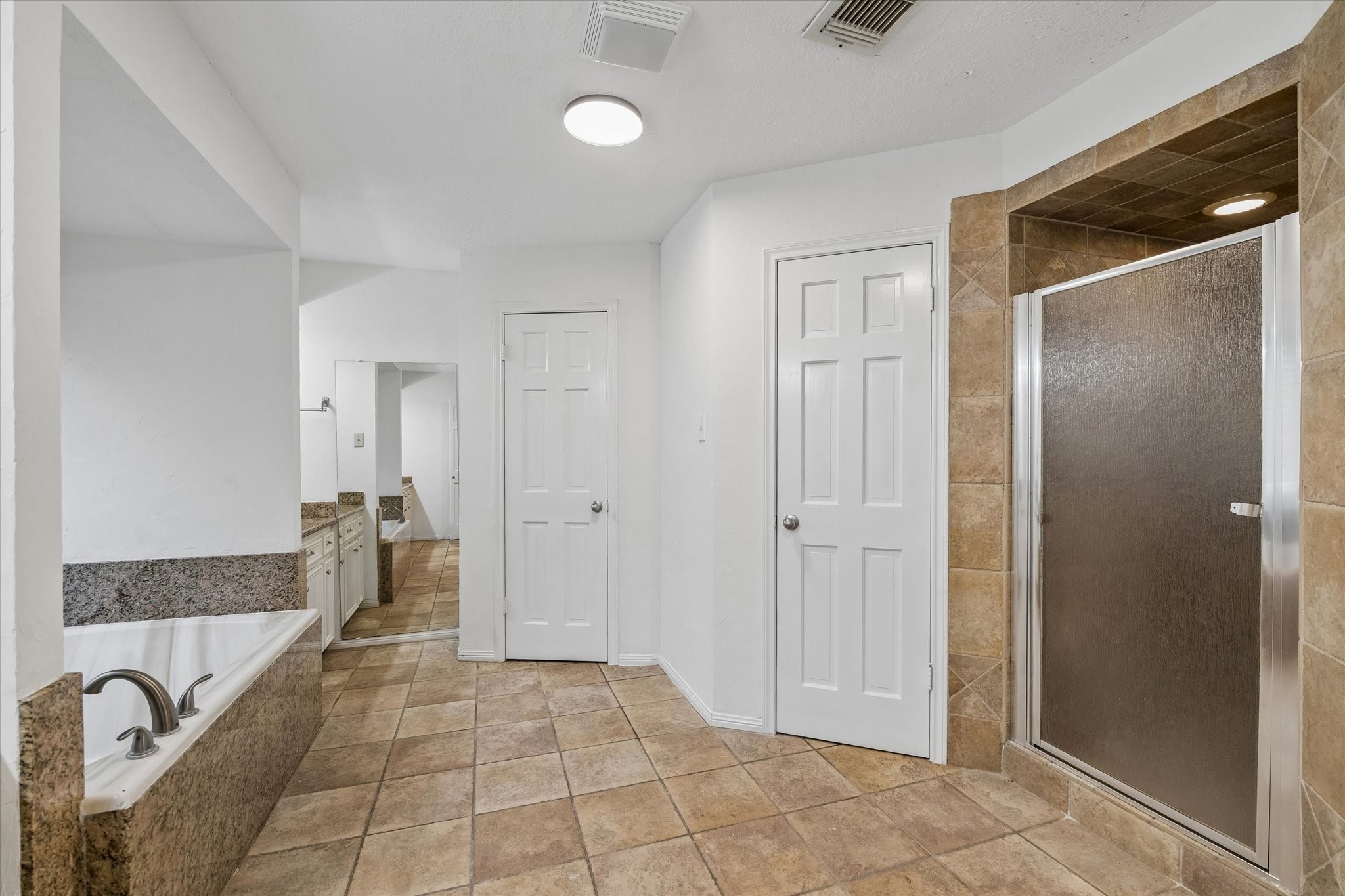 17902 Fernbluff Drive Spring, TX 77379 - Photo 17 of 29 a spacious bathroom with a granite countertop sink and shower