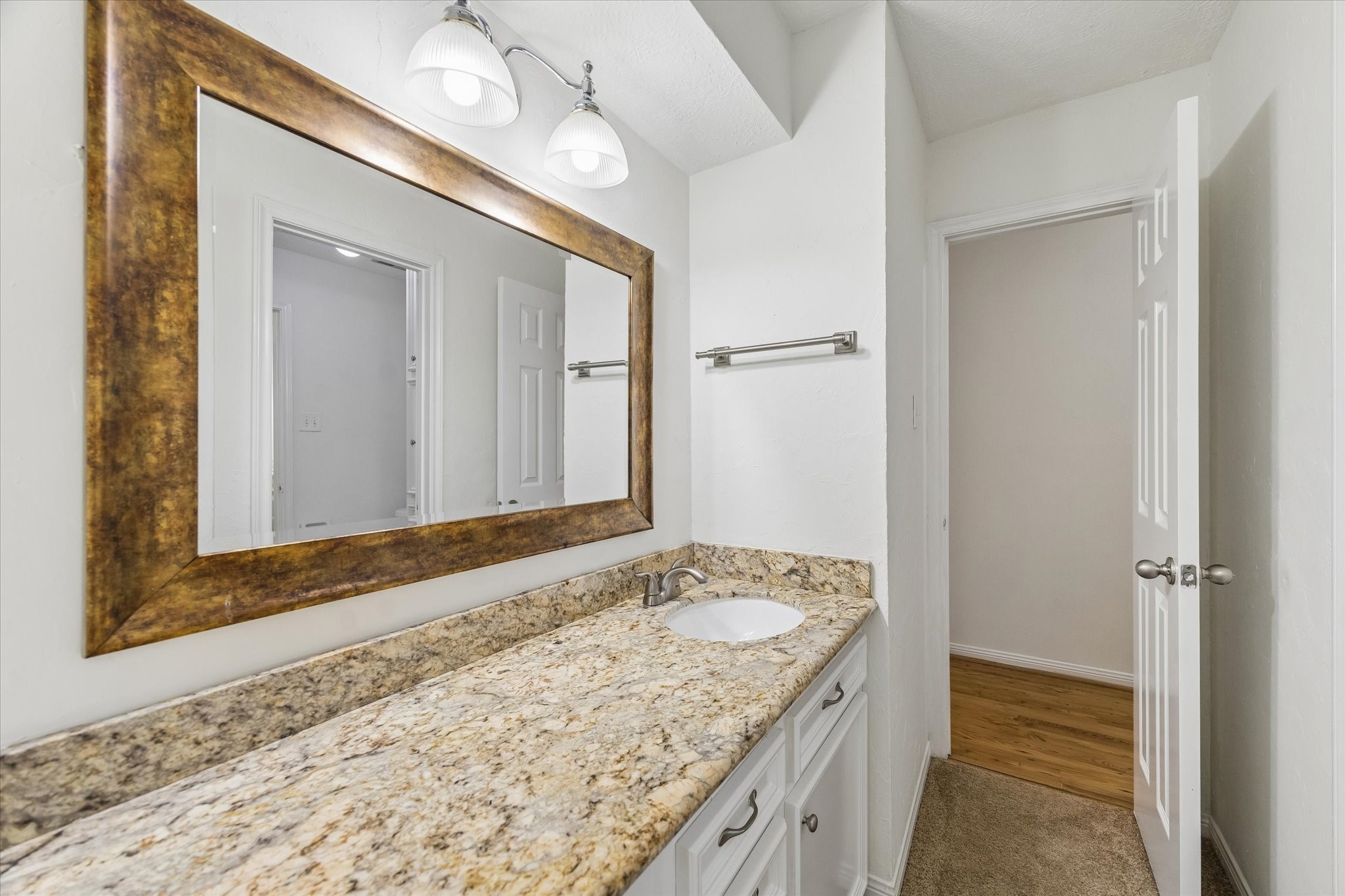 17902 Fernbluff Drive Spring, TX 77379 - Photo 19 of 29 a bathroom with a granite countertop sink and a mirror