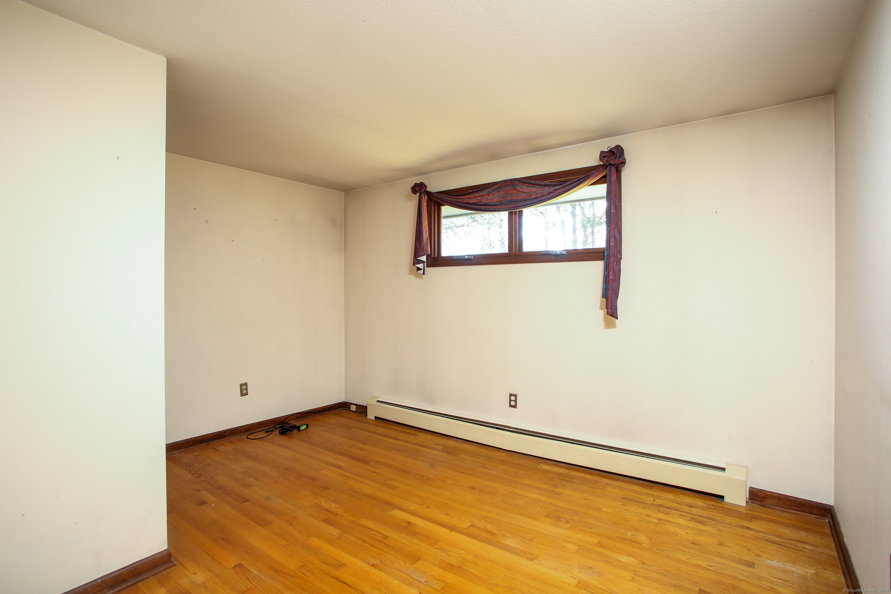 118 Washinee Heights Road Salisbury, CT 06068 - Photo 13 of 31 an empty room with wooden floor and windows