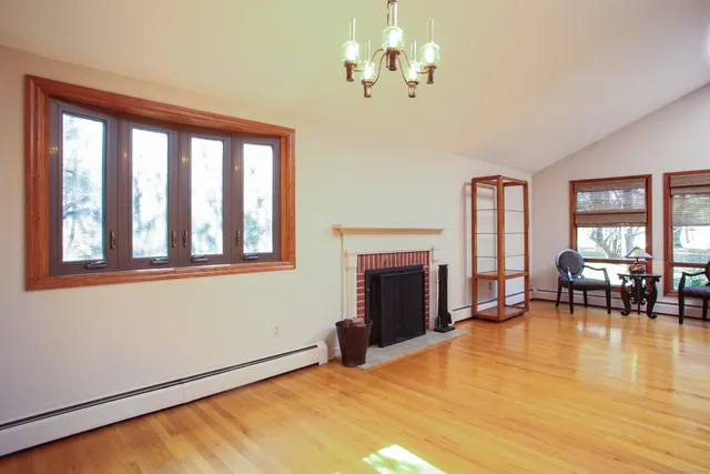 a bedroom with furniture fireplace and windows