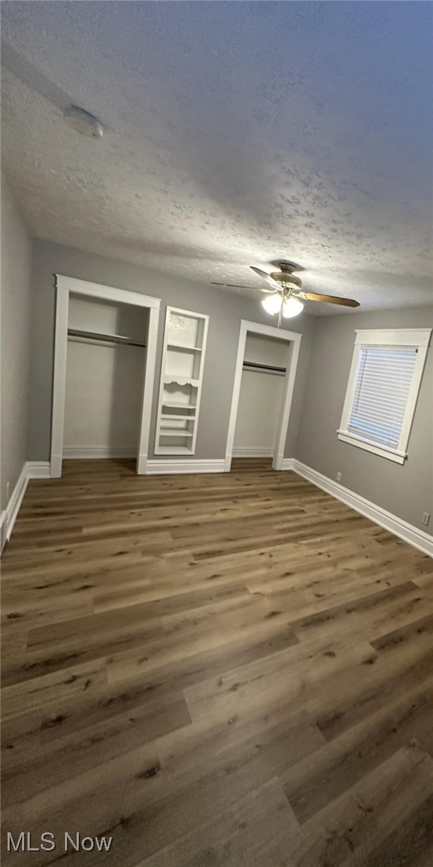 274 Ruckel Road Akron, OH 44305 - Photo 8 of 21 Unfurnished bedroom with a textured ceiling, ceiling fan, and dark wood-type flooring