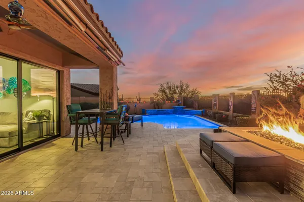 a view of a patio with swimming pool table and chairs