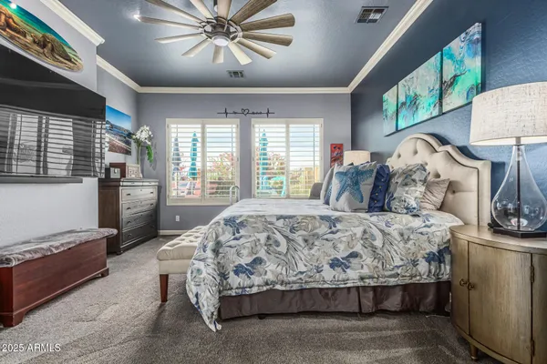 a bed sitting in a bedroom next to a window