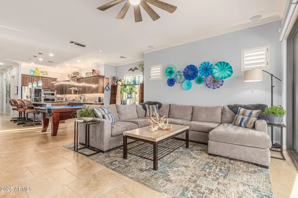 a living room with furniture and a view of kitchen