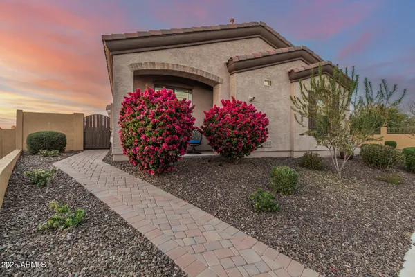 a view of a house with a small yard and potted plants