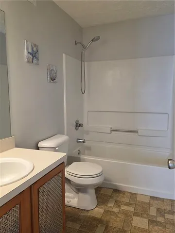 a bathroom with a sink a toilet and a shower