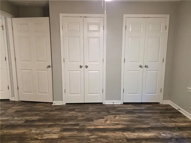 a view of wooden floor and closet area