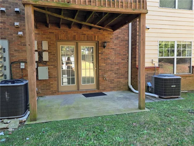 a view of front door of house with outdoor seating