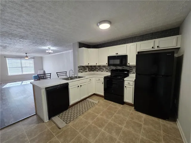 a kitchen with a sink stove and refrigerator