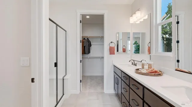 a bathroom with a double vanity sink and mirror
