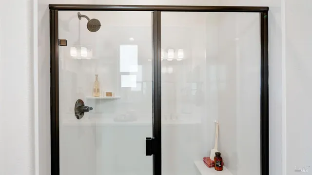a bathroom with a tub sink and mirror