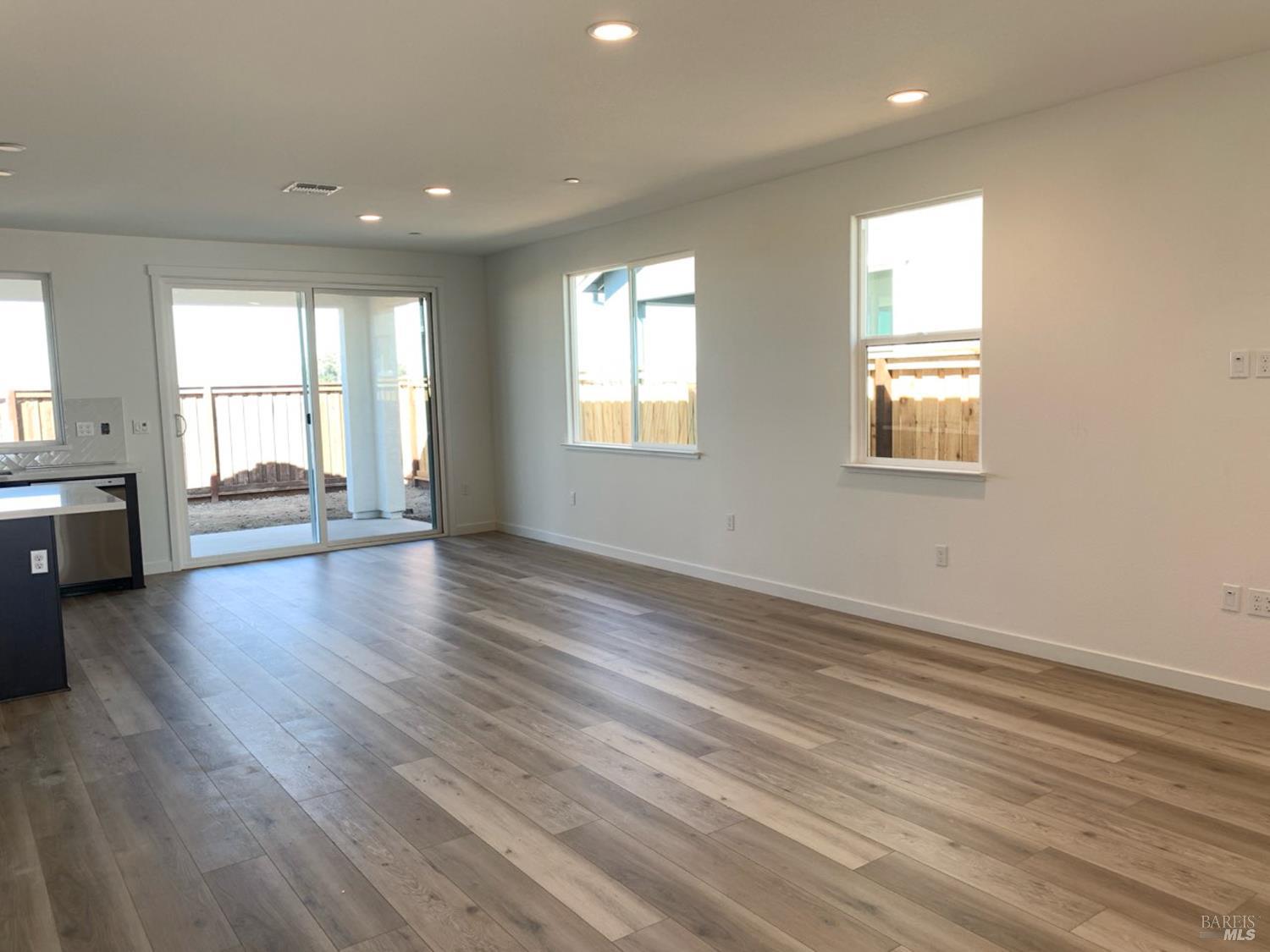 2640 Hopscotch Street Rio Vista, CA 94571 - Photo 5 of 51 an empty room with wooden floor and windows