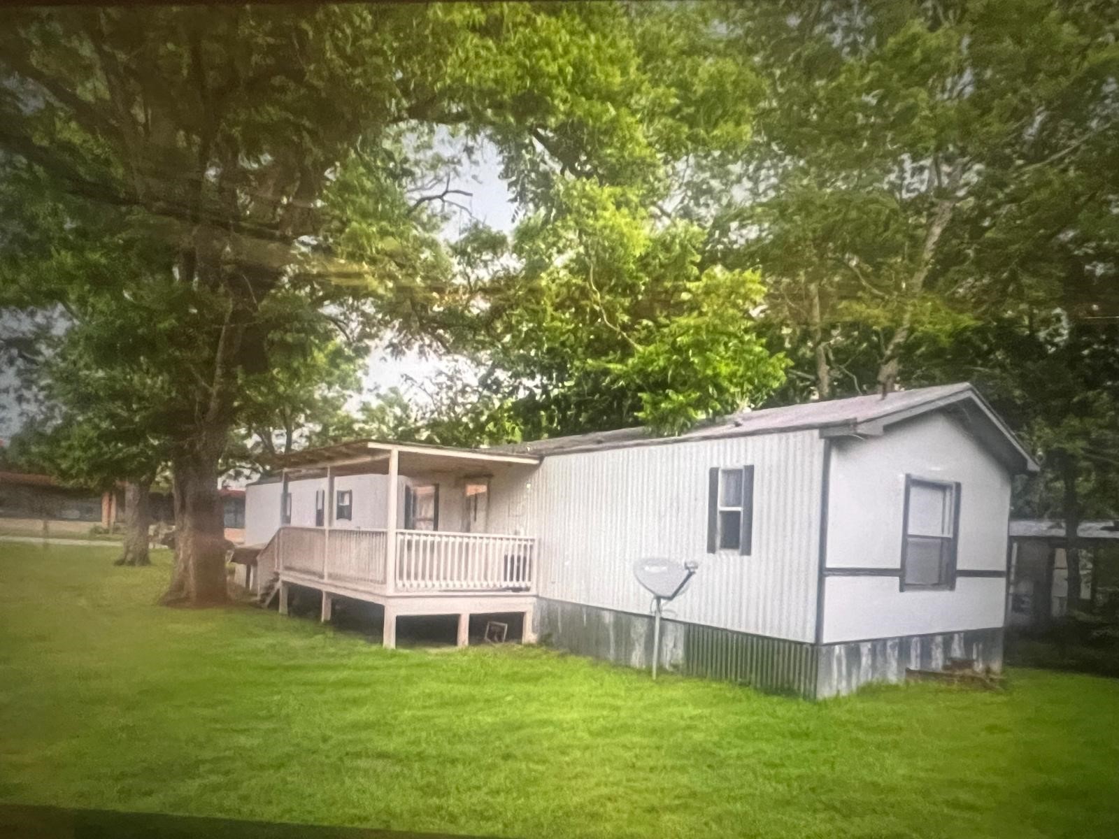 a view of a house with a yard and sitting area