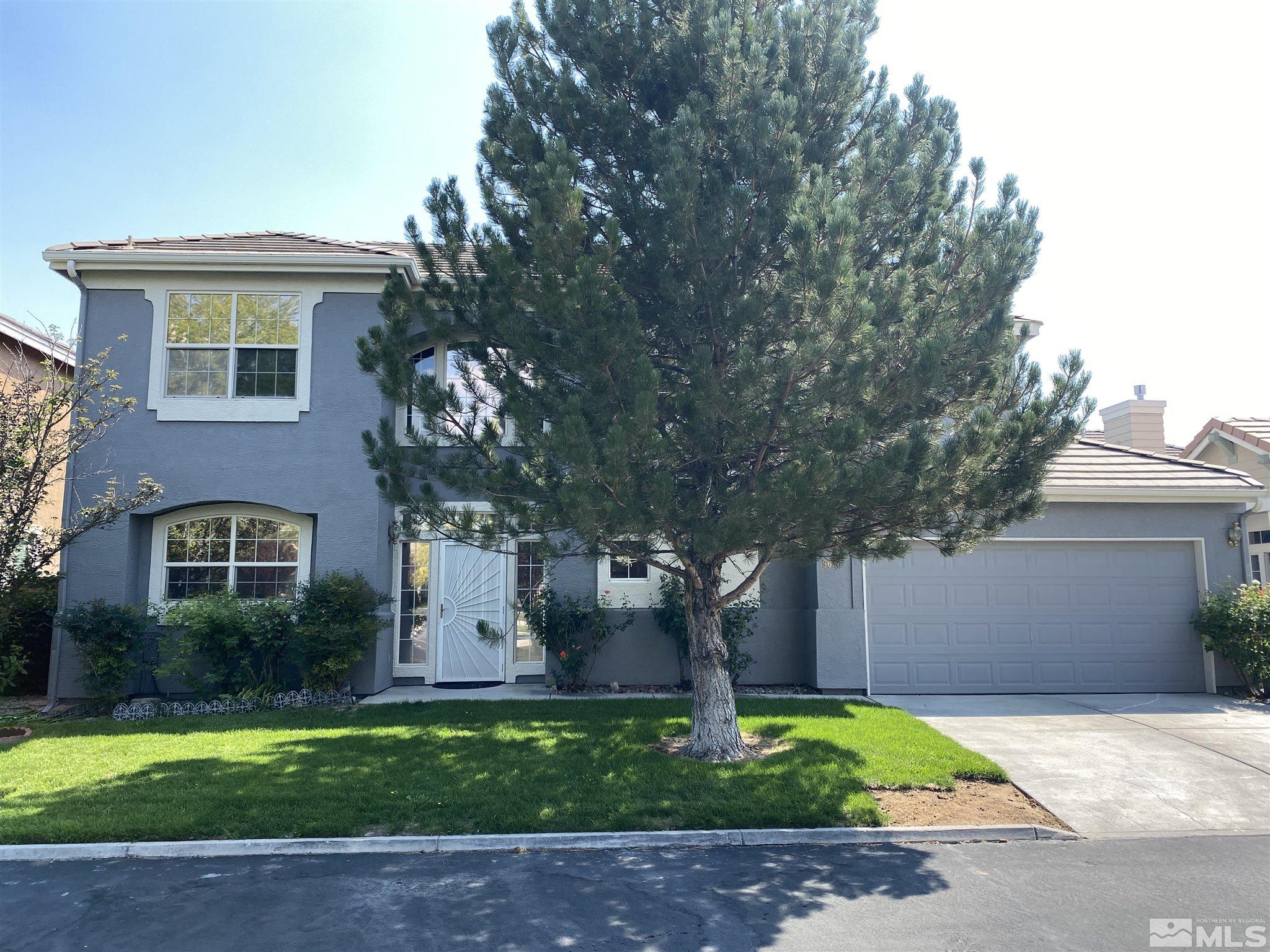 9636 Truckee Meadows Place Reno, NV 89521 - Photo 1 of 21 a front view of a house with garden