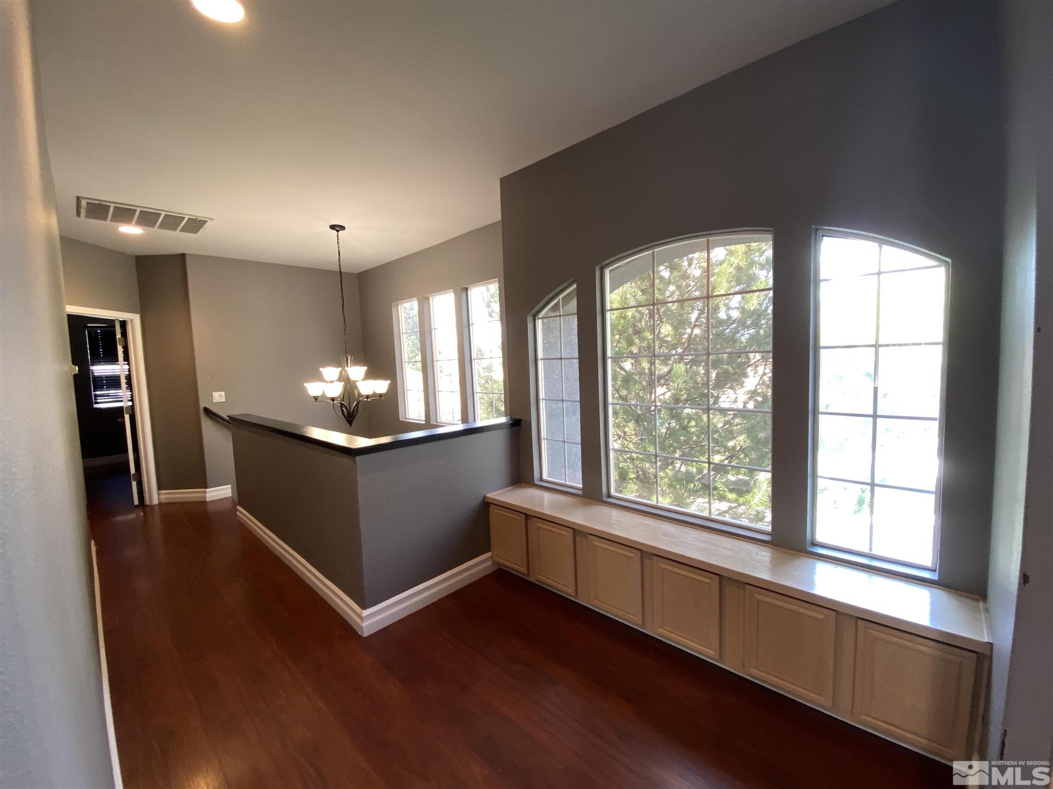 9636 Truckee Meadows Place Reno, NV 89521 - Photo 11 of 21 wooden floor in an empty room with a window
