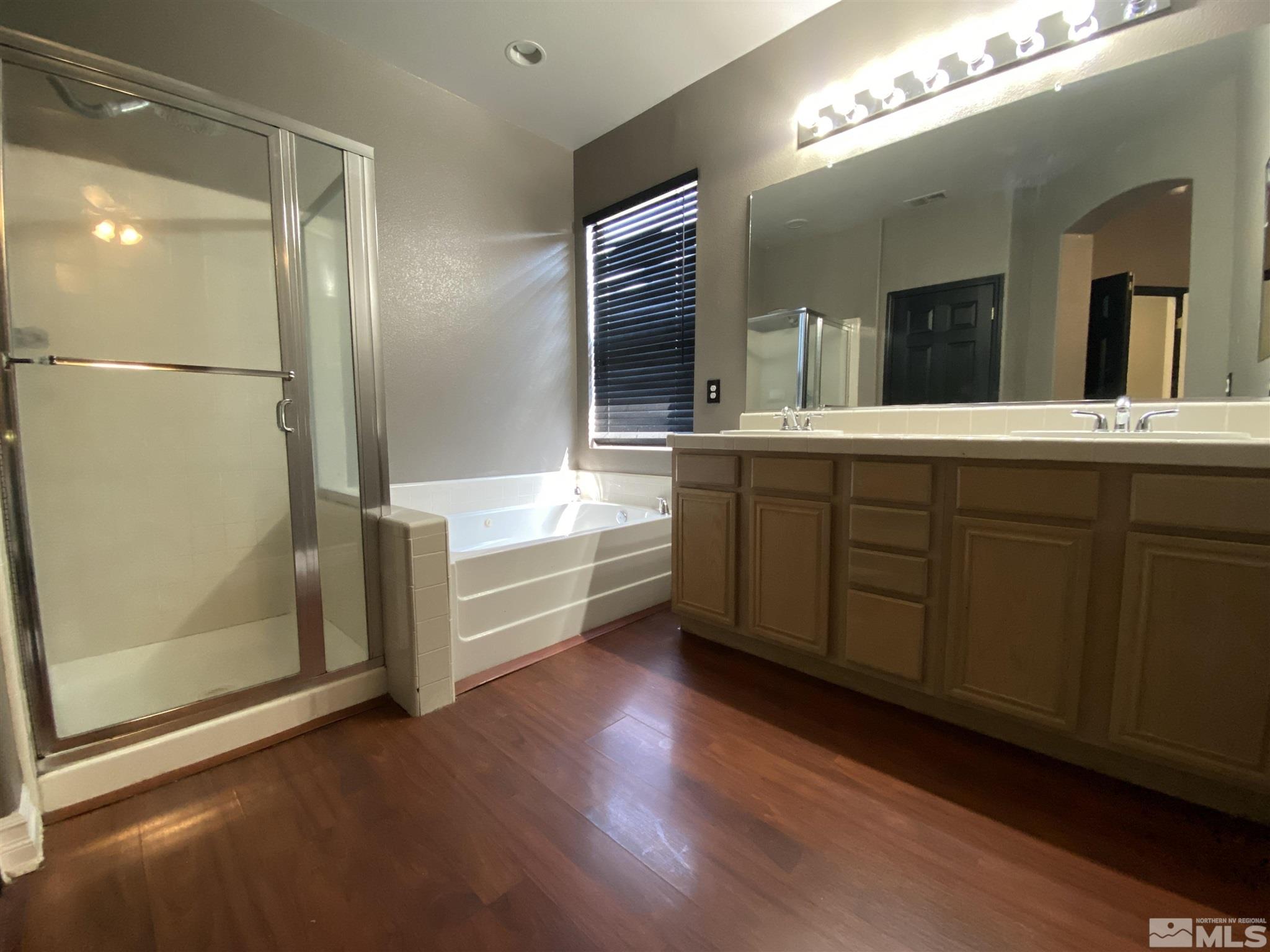 9636 Truckee Meadows Place Reno, NV 89521 - Photo 14 of 21 a spacious bathroom with a tub sink and mirror