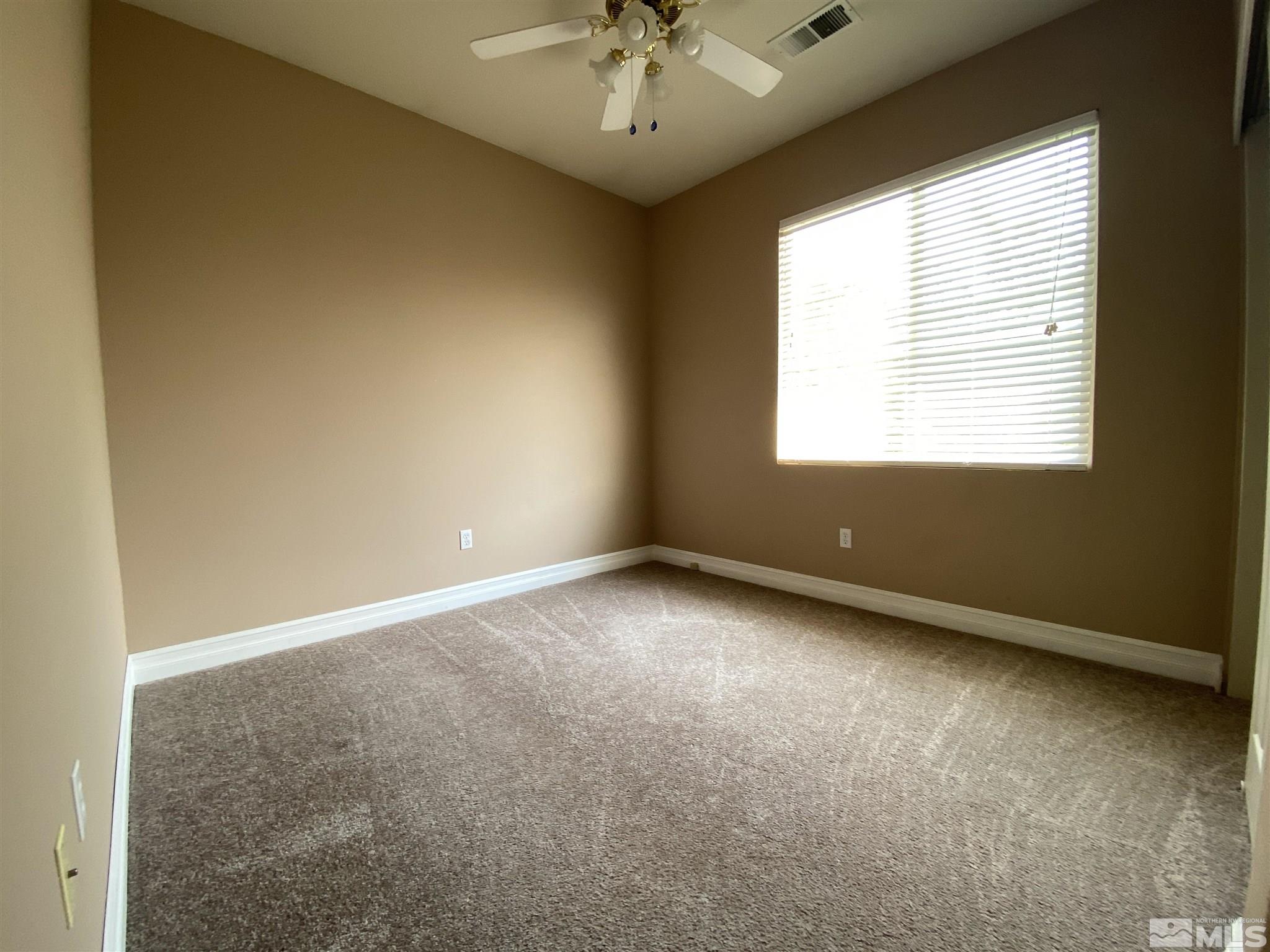9636 Truckee Meadows Place Reno, NV 89521 - Photo 17 of 21 an empty room with a window and a ceiling fan
