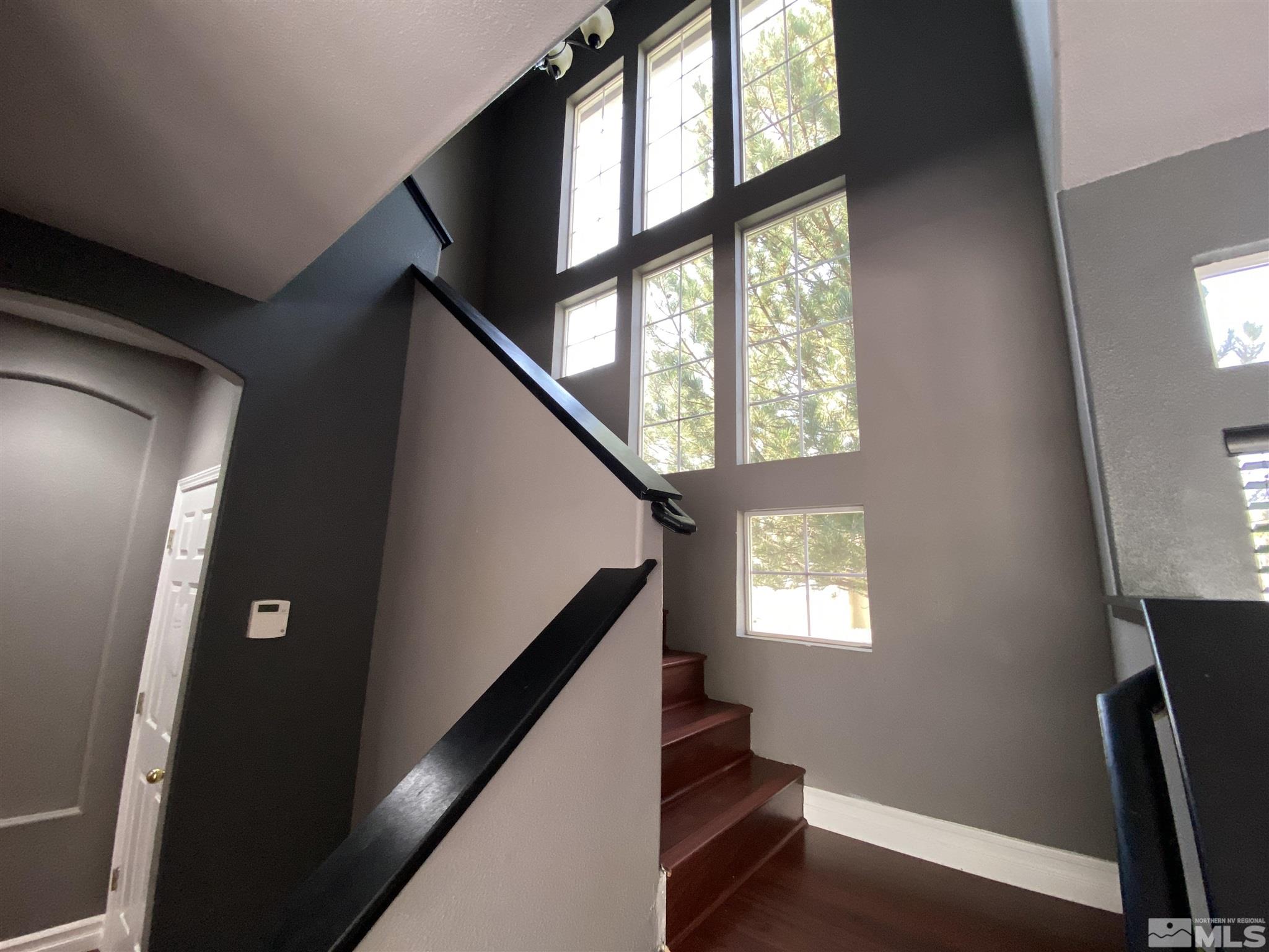 9636 Truckee Meadows Place Reno, NV 89521 - Photo 9 of 21 a view of an entryway with wooden floor and windows