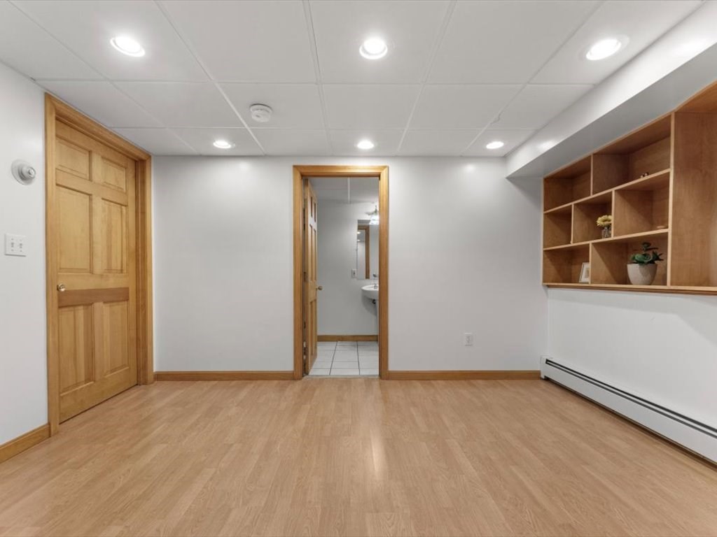 769 Edgell Road Framingham, MA 01701 - Photo 24 of 37 an empty room with wooden floor and windows