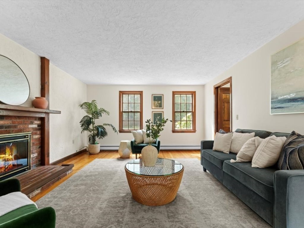 769 Edgell Road Framingham, MA 01701 - Photo 6 of 37 a living room with furniture a fireplace and a potted plant