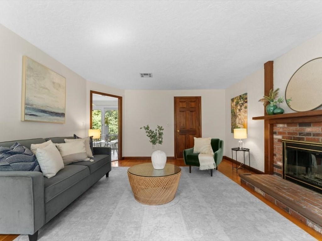 769 Edgell Road Framingham, MA 01701 - Photo 8 of 37 a living room with furniture a window and a fireplace