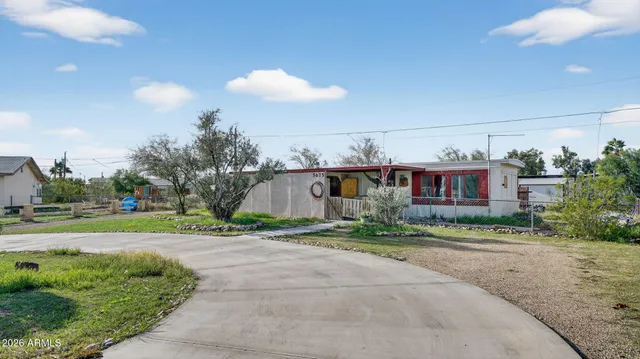 a view of a house with a yard and a patio