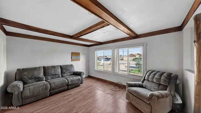 a living room with a couch and a wooden floor