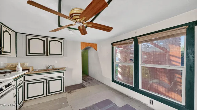 a open kitchen with stainless steel appliances granite countertop a stove and a sink