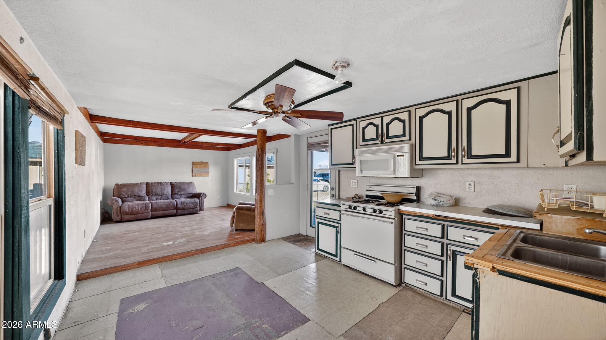 5675 Rocky Road Fort Mohave, AZ 86426 - Photo 22 of 30 a kitchen with stainless steel appliances granite countertop a sink and cabinets