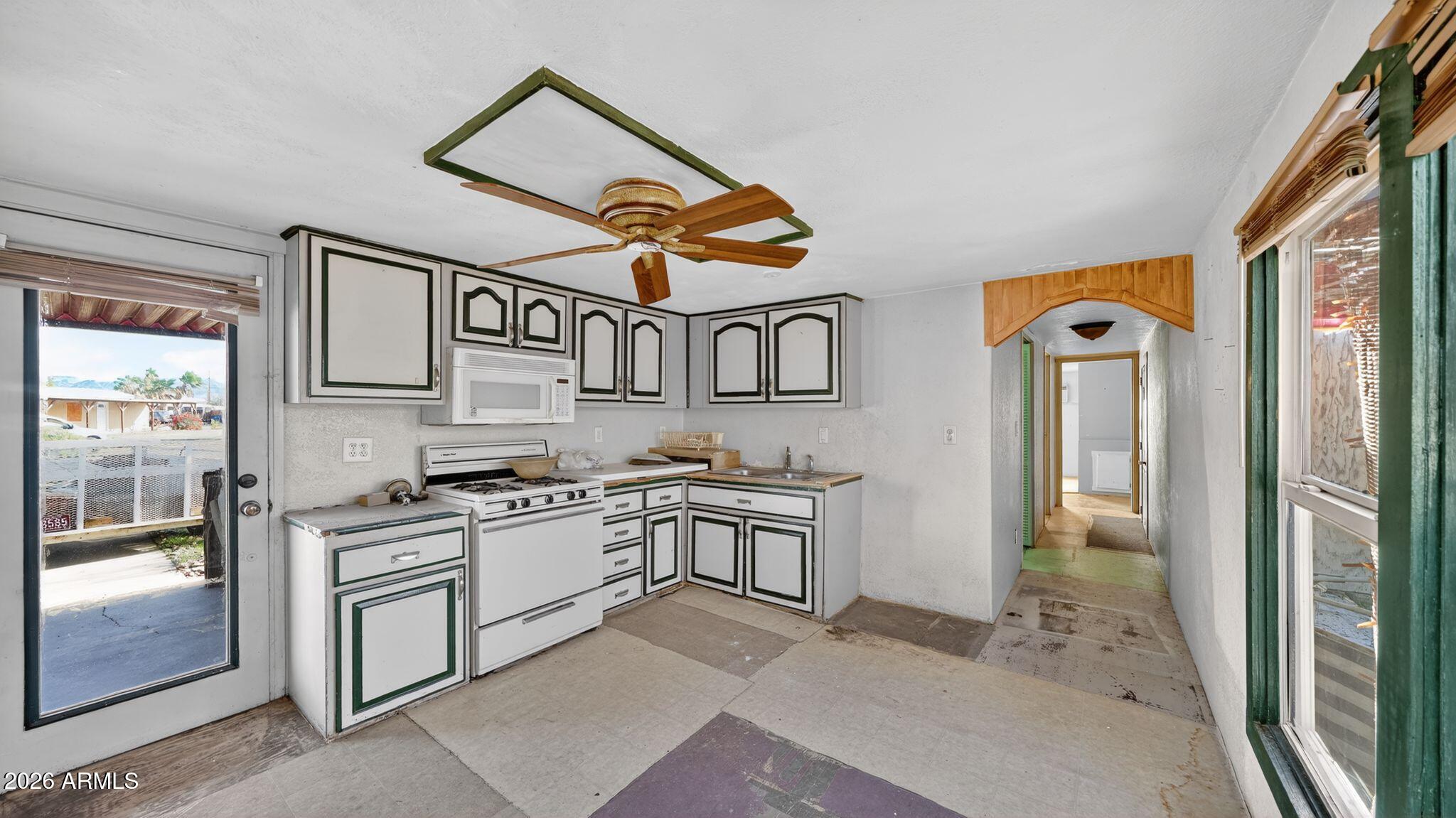 5675 Rocky Road Fort Mohave, AZ 86426 - Photo 23 of 30 a open kitchen with stainless steel appliances granite countertop a stove and a sink