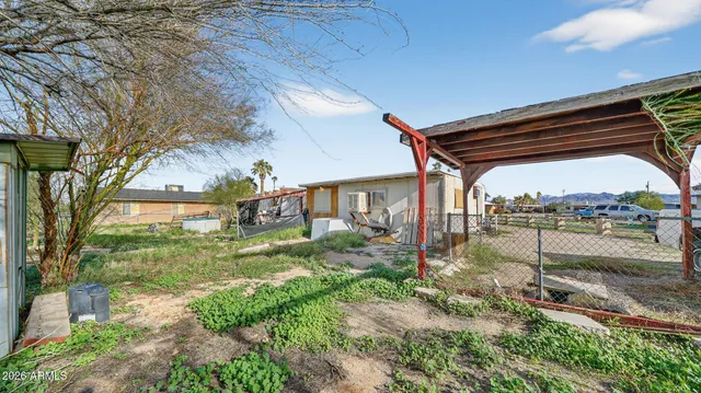 a view of a house with a yard and a lake view