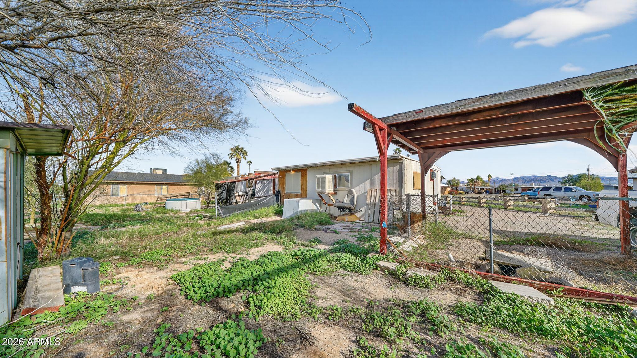 5675 Rocky Road Fort Mohave, AZ 86426 - Photo 9 of 30 a view of a house with a yard and a lake view