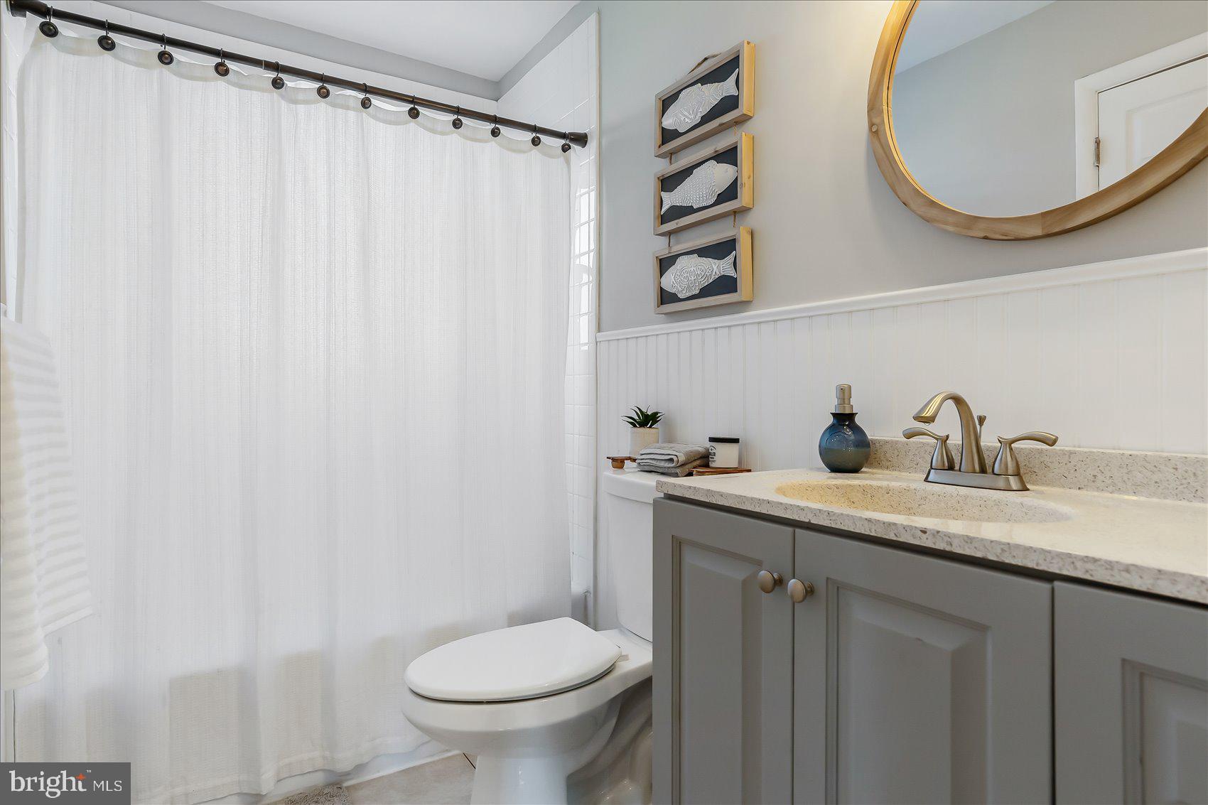 6934 River Drive Road Sparrows Point, MD 21219 - Photo 23 of 47 a bathroom with a granite countertop sink and a mirror