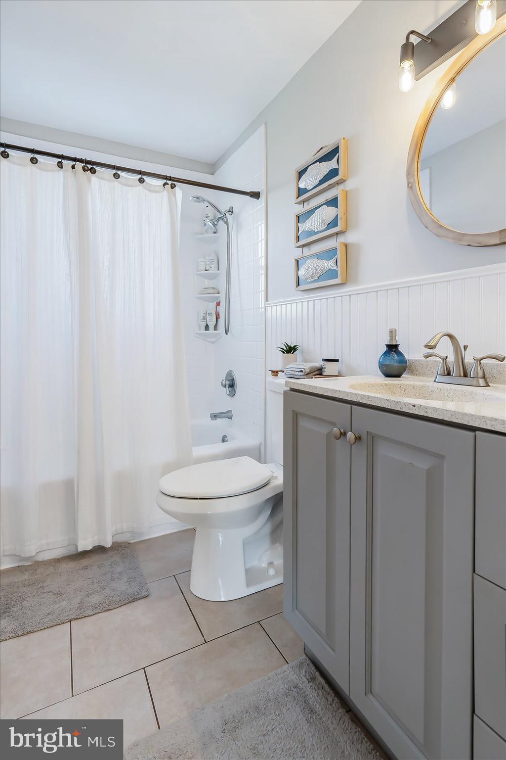 6934 River Drive Road Sparrows Point, MD 21219 - Photo 24 of 47 a bathroom with a toilet sink a mirror and vanity