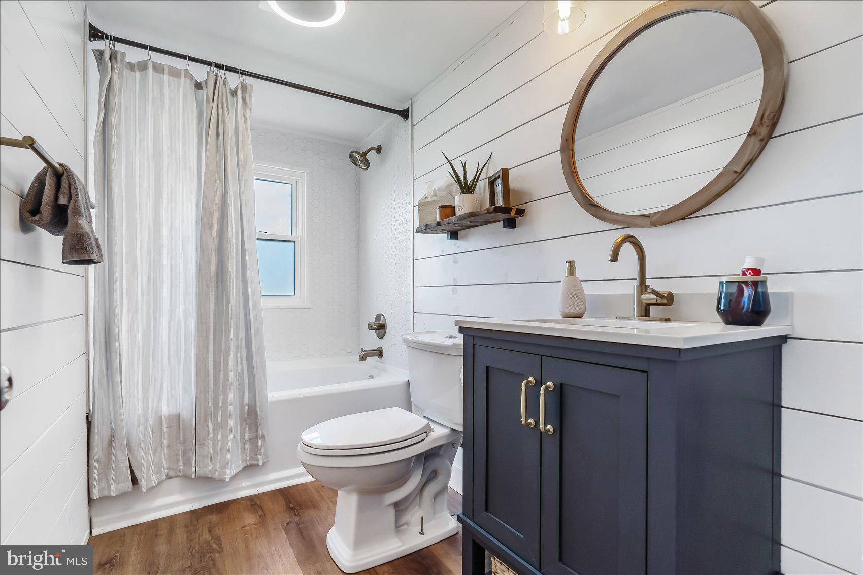 6934 River Drive Road Sparrows Point, MD 21219 - Photo 28 of 47 a bathroom with a sink a toilet and a mirror