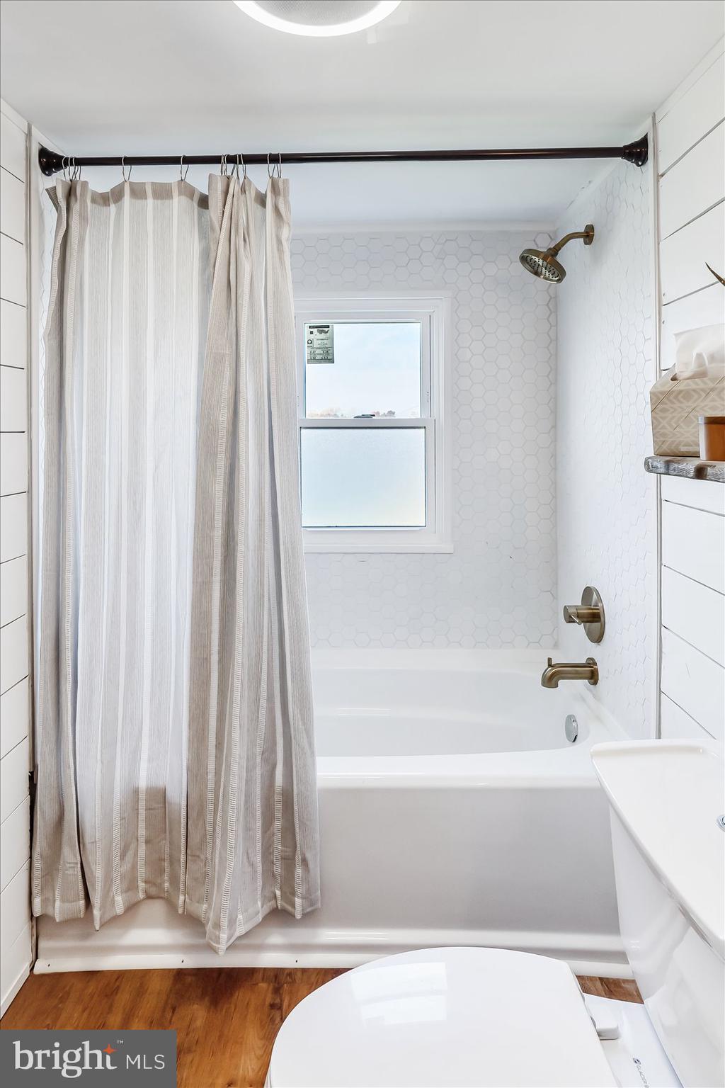 6934 River Drive Road Sparrows Point, MD 21219 - Photo 29 of 47 a bathroom with a bathtub and a shower