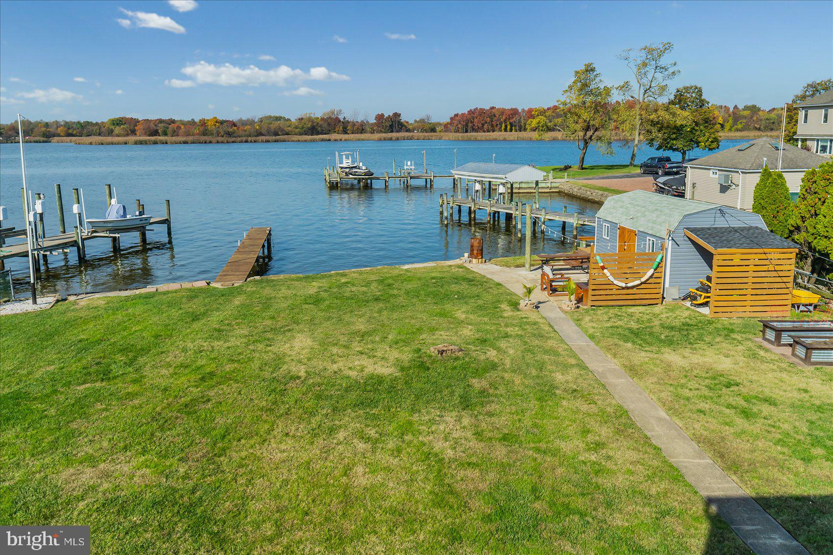 6934 River Drive Road Sparrows Point, MD 21219 - Photo 38 of 47 a view of a lake with houses in the back