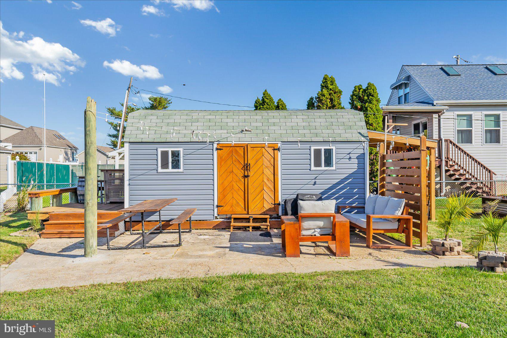 6934 River Drive Road Sparrows Point, MD 21219 - Photo 41 of 47 a backyard of a house with sofas table and chairs