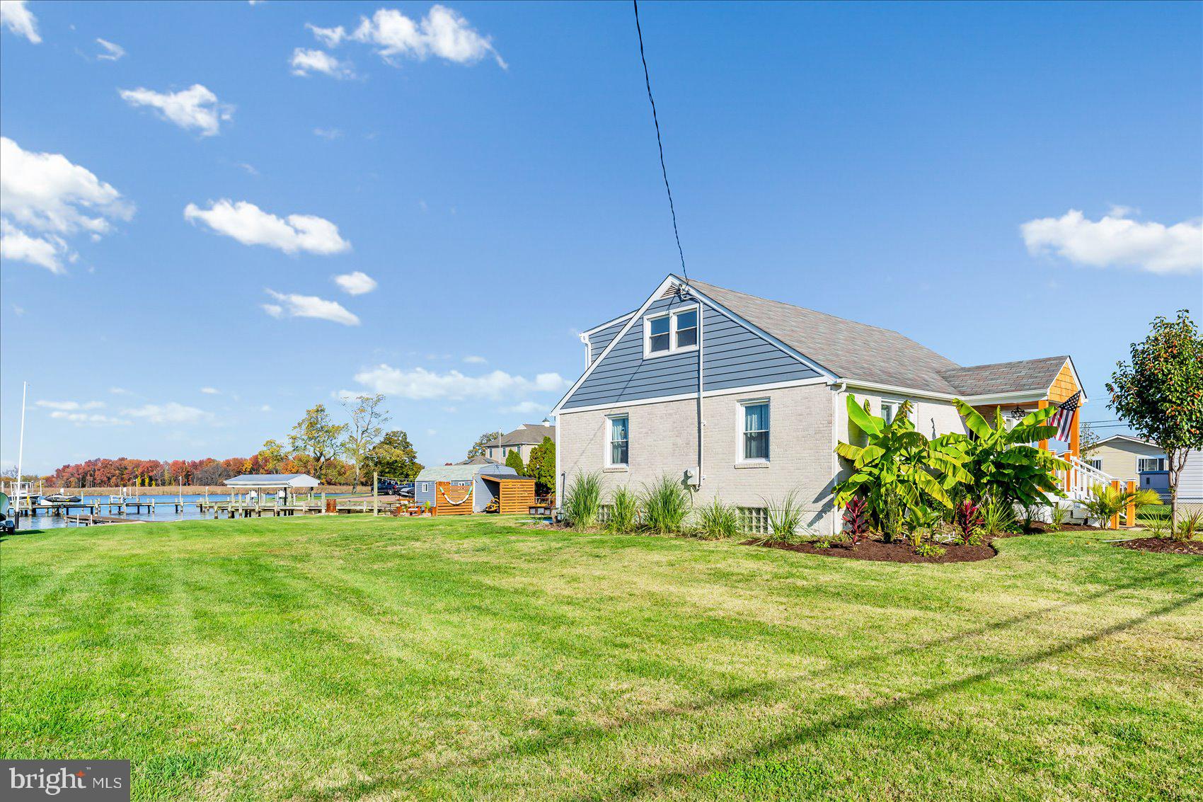 6934 River Drive Road Sparrows Point, MD 21219 - Photo 5 of 47 a front view of a house with a yard