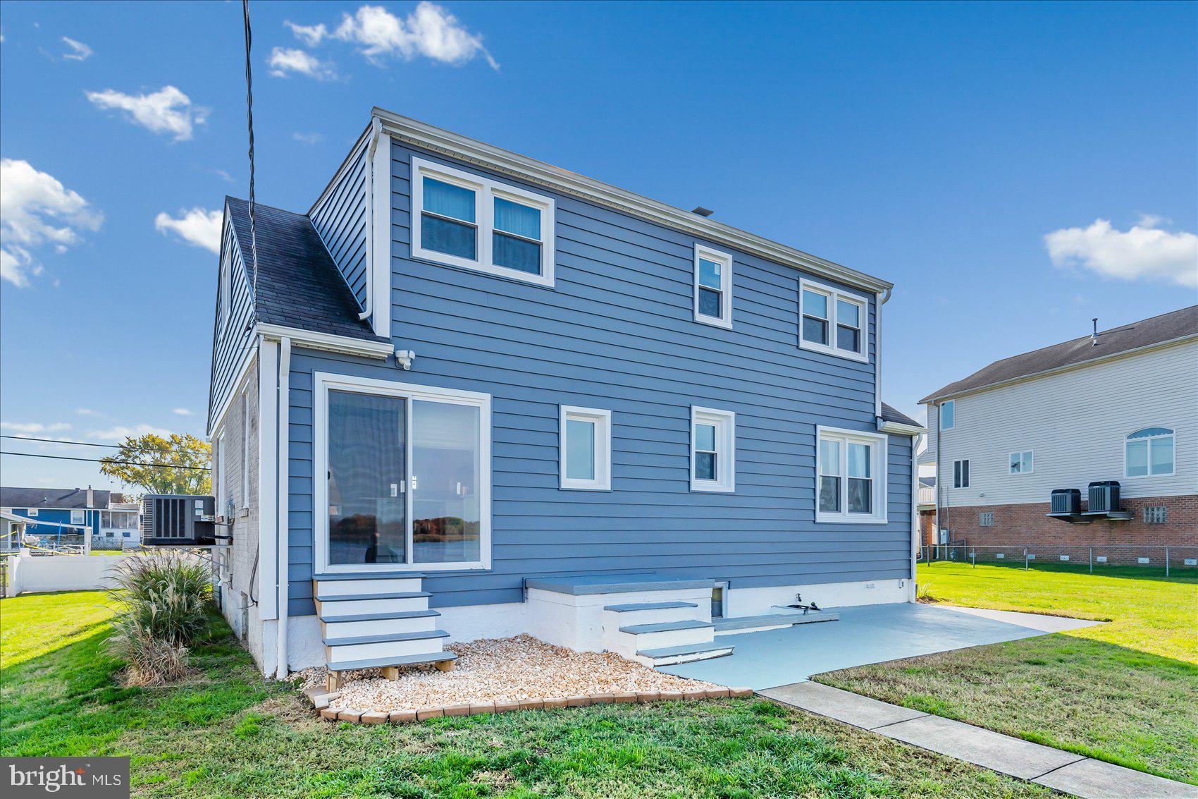 6934 River Drive Road Sparrows Point, MD 21219 - Photo 7 of 47 a view of house with backyard outdoor seating and swimming pool