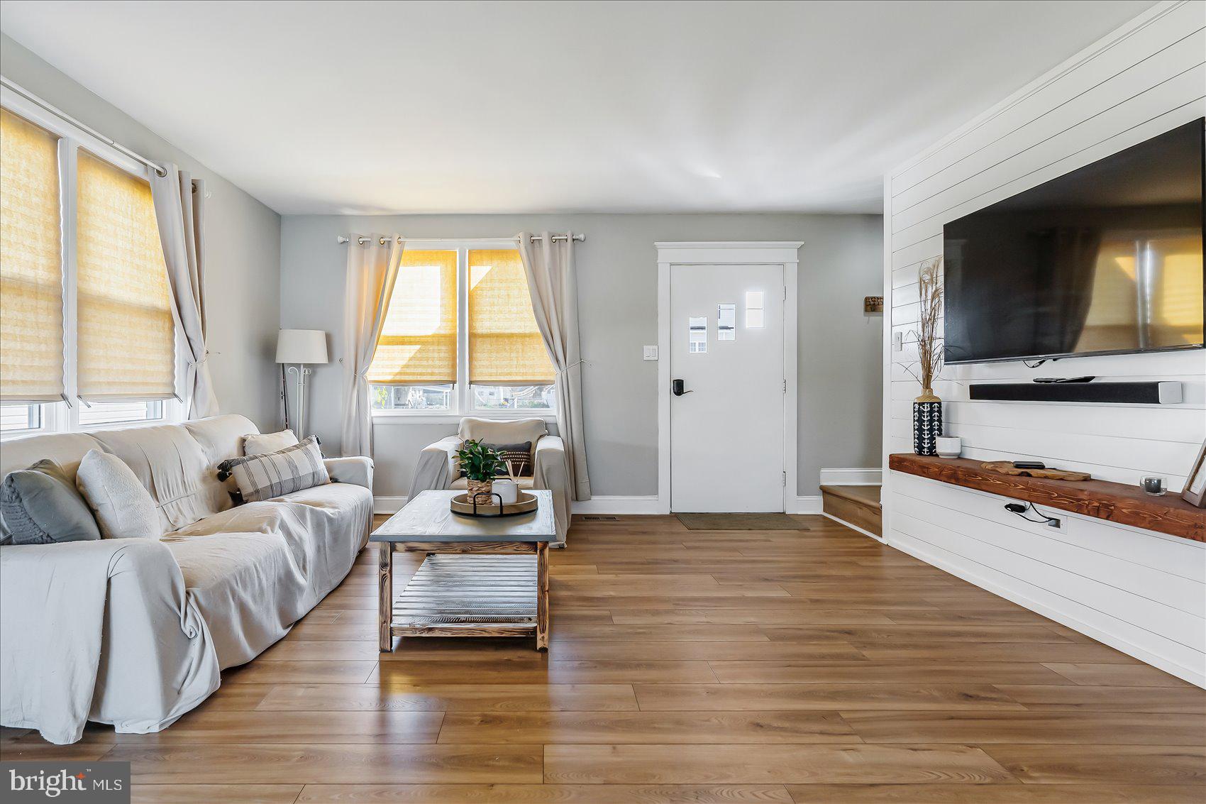 6934 River Drive Road Sparrows Point, MD 21219 - Photo 9 of 47 a living room with furniture and a flat screen tv