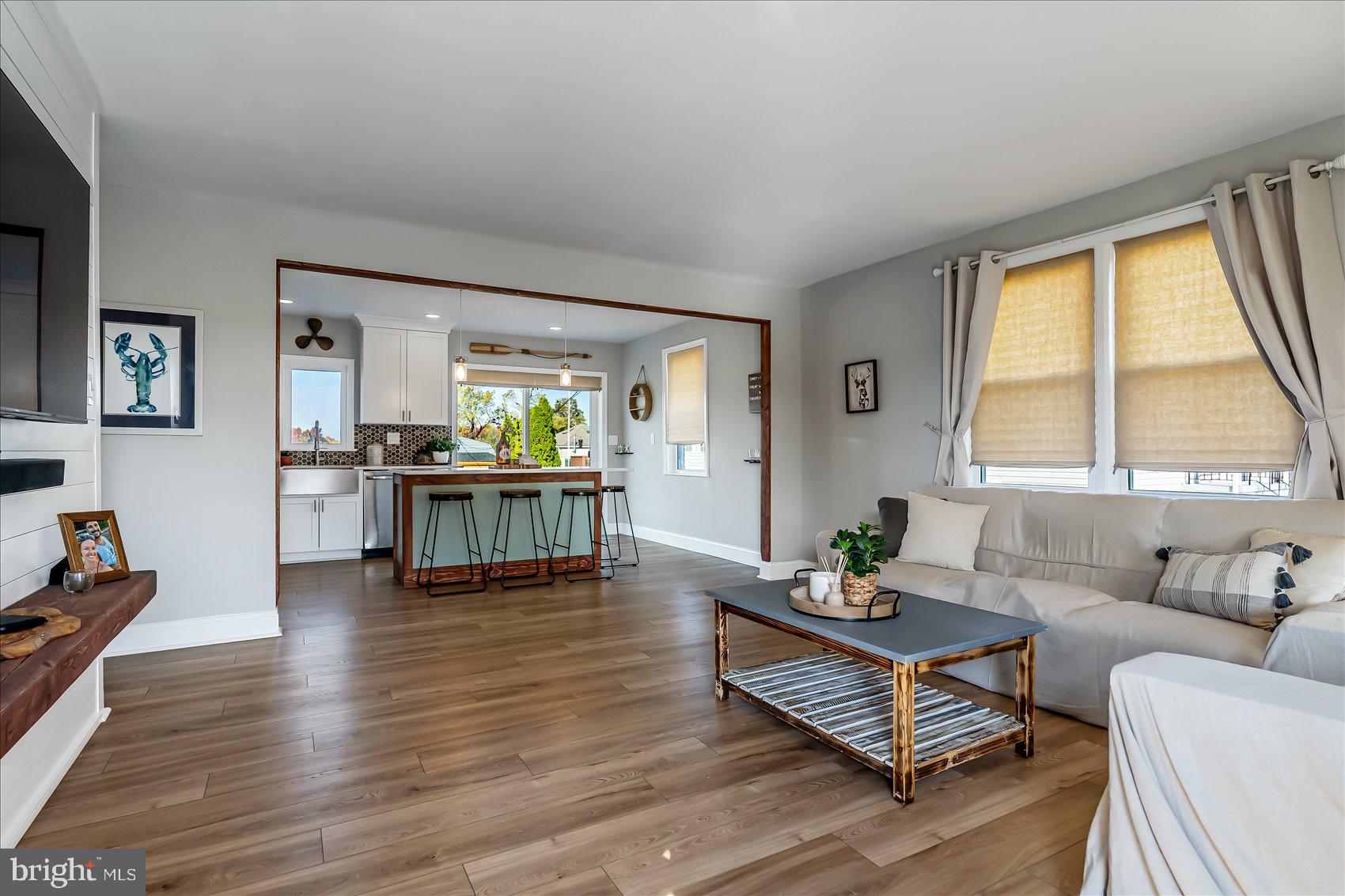 6934 River Drive Road Sparrows Point, MD 21219 - Photo 10 of 47 a living room with furniture and large windows