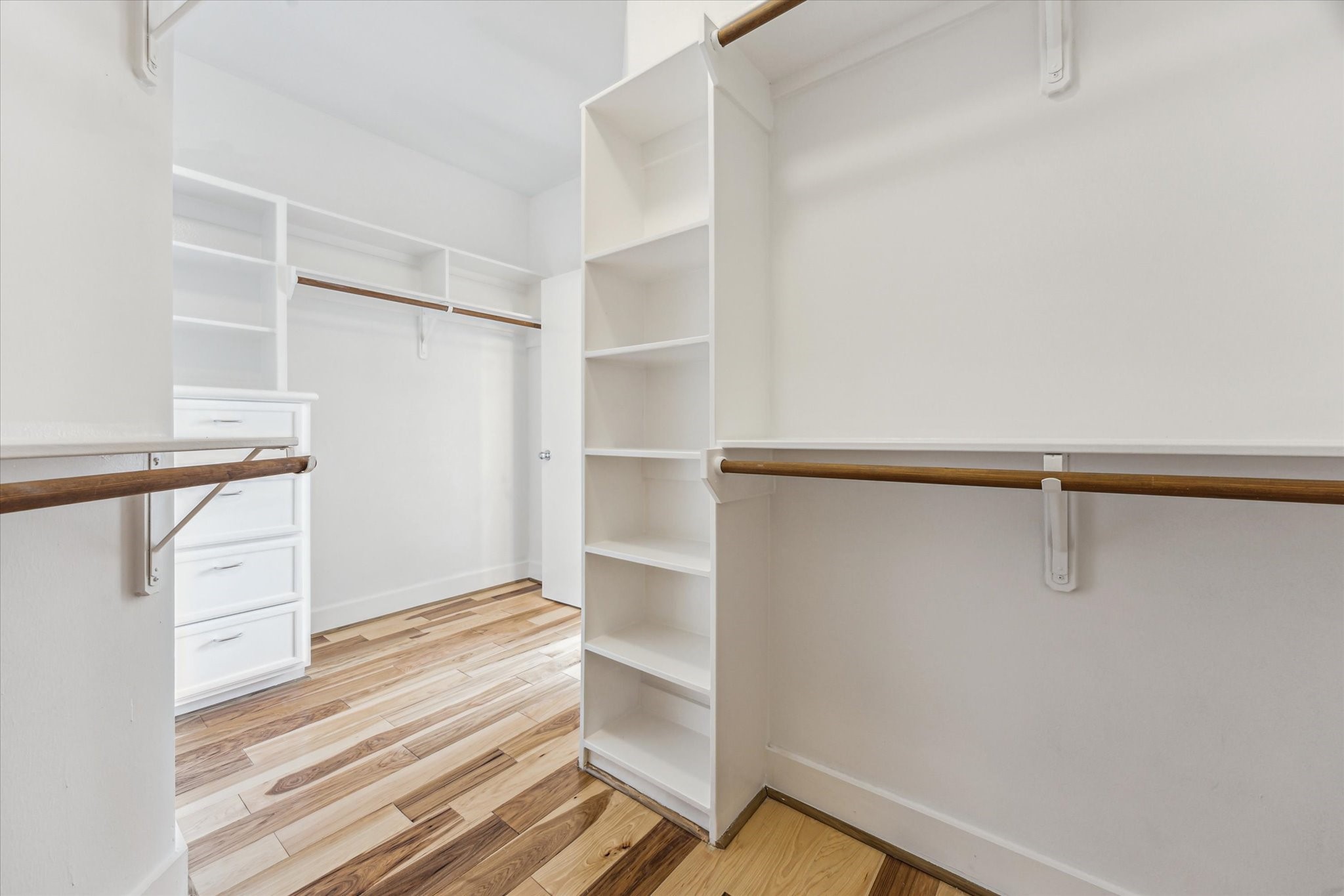 9829 Riddlelink Lane Houston, TX 77025 - Photo 13 of 22 Generous walk-in closet with built-in shelving and drawers offering ample organization and storage options.