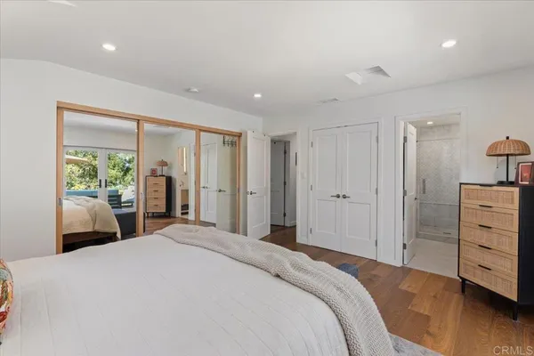 a bedroom with a bed and a large window