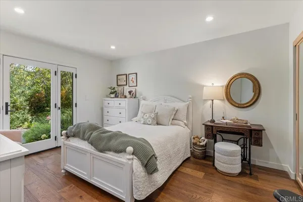 a bedroom with a bed and a mirror